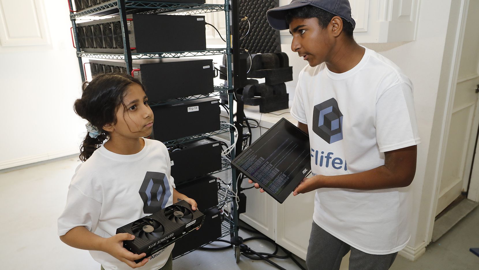 Siblings Ishaan and Aanya Thakur holding mining equipment