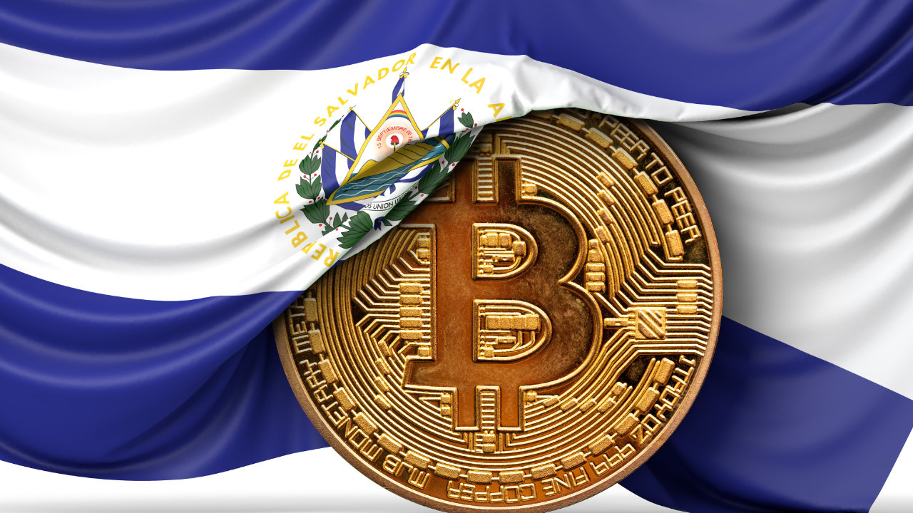 Picture of a gold bitcoin with El Salvador flag half draped over it